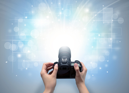 Hand taking photo with glowing flash conceptの写真素材