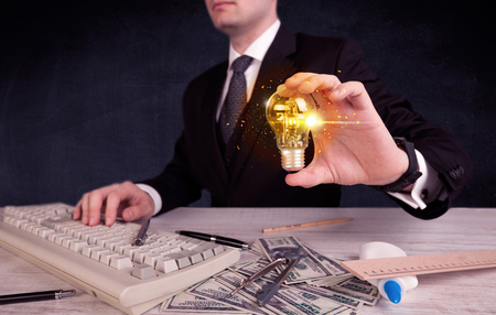 office worker holding a light bulbの写真素材