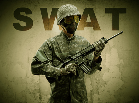 Armed soldier with damaged wall background