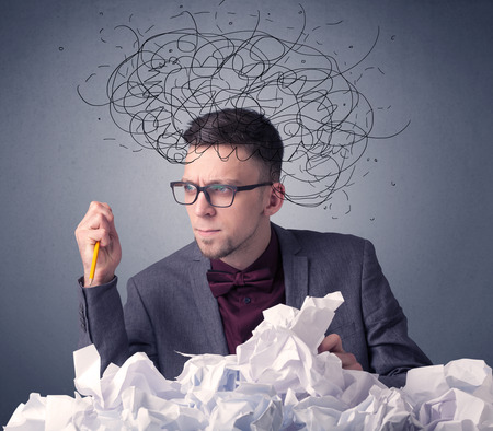 Businessman above crumpled paperの写真素材