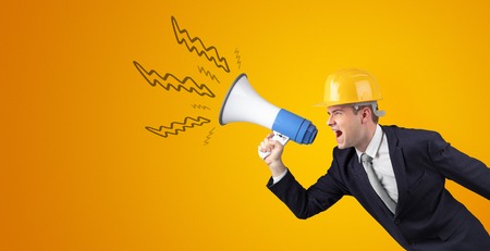 Young architect yelling with megaphoneの写真素材