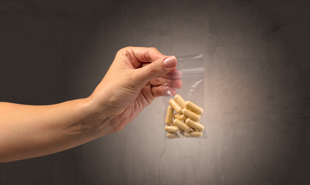 Giving drugs in plastic bagの写真素材