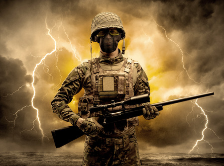 Armed soldier standing in an obscure weatherの写真素材