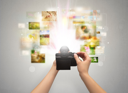 Hand captures life events with digital cameraの写真素材