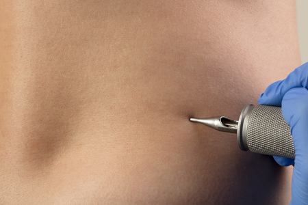 Hand tattooing on naked clear skinの写真素材