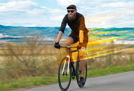 Young riding bicycle in natureの写真素材