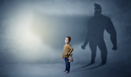 Cute kid with hero shadow behindの写真素材