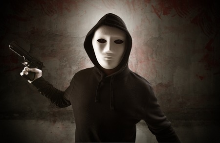 Armed assassin in an empty bloody room conceptの写真素材