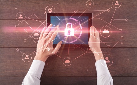 Hand using tablet with network security and online storage system concept