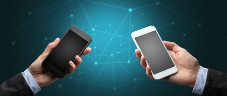 Close up of two hands holding smartphones