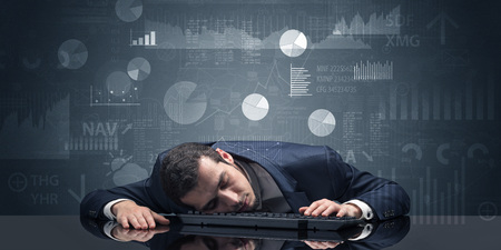 Businessman sleeping with charts, graphs and reports conceptの写真素材