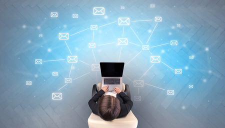 Mail symbols with woman using deviceの写真素材