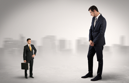 Giant businessman is  afraid of small executorの写真素材