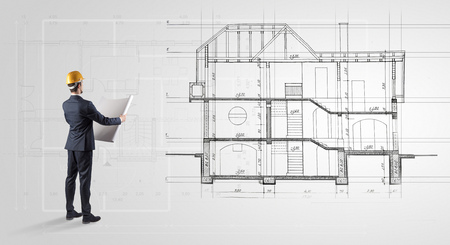 Architect looking to a house planの写真素材
