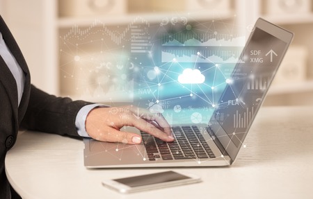 Business woman working on laptop with cloud technology conceptの写真素材