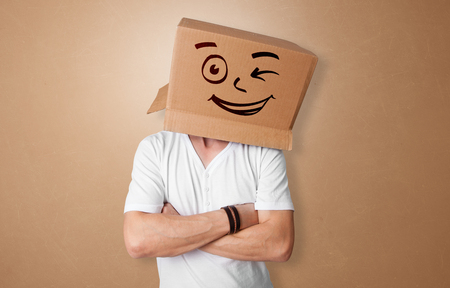 Young man  with happy cardboard box faceの写真素材