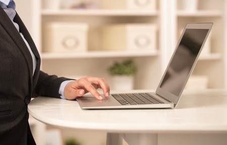 Business woman working on her laptop in a cozy environmentの写真素材