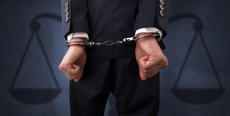 Arrested man with balance on the backgroundの写真素材