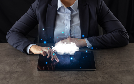 Business woman working on tablet with cloud technology and network concept