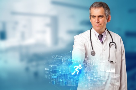 Doctor touching hologram screen displaying healthcare running symbolsの写真素材