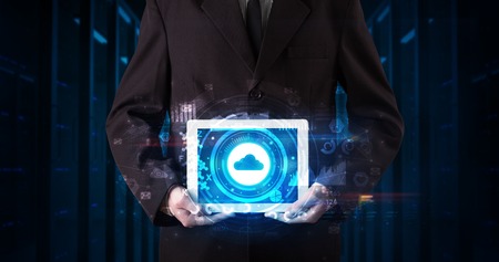 Hand holding tablet with cloud technology and dark concept