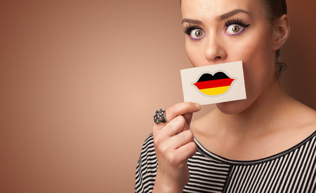 Person holding Germany flag lips shape cardの写真素材