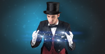 Magician with blue background and geometrical connection between two handsの写真素材
