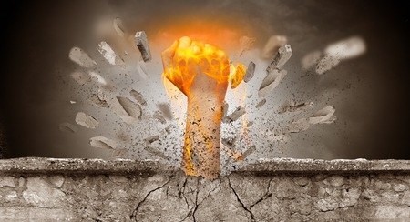 Big hand hits intense and breaks a crass stonewallの写真素材