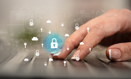Business woman hand typing on keyboard with secured lock concept around