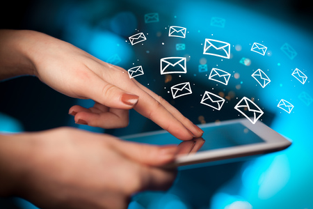 Hand holding tablet with online communication conceptの写真素材