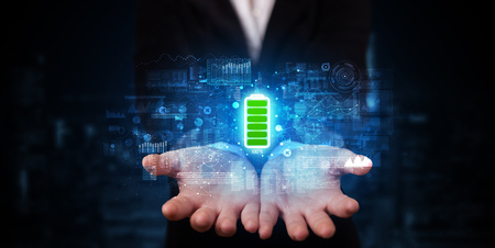 Elegant hand holding battery with full of energyの写真素材