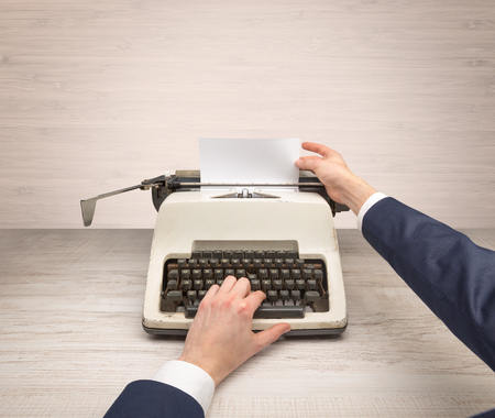 First person perspective elegant hand writing on an oldschool typewriter with copyspaceの写真素材