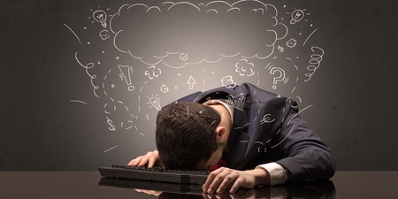 Young elegant businessman fell asleep at his workplace with doodled idea, sleep and tired conceptの写真素材