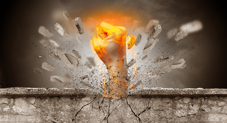 Big hand hits intense and breaks a crass stonewallの写真素材