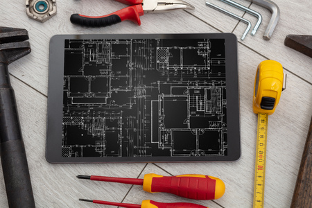 Tablet with construction tools and blueprint conceptの写真素材