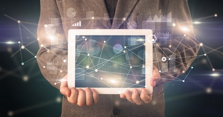 Elegant hand holding tablet with virtual database and network concept