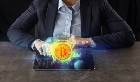 Business woman working on tablet with cryptocurrency and network conceptの写真素材