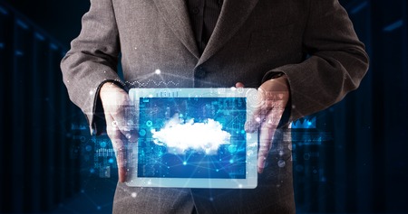 Hand holding tablet with cloud technology and dark conceptの写真素材