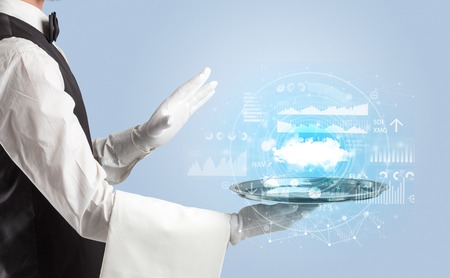 Elegant young waiter serving cloud technology conceptの写真素材