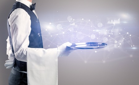 Young waiter serving financial concept on a metal trayの写真素材