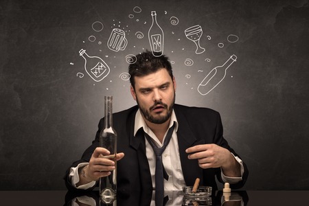 Drunk down and out man with doodle alcohol bottles conceptの写真素材