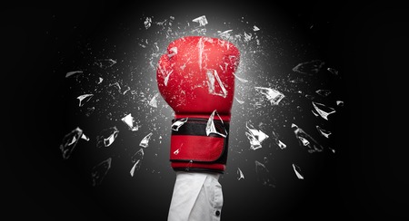 Big hand hits intense and breaks glassesの写真素材