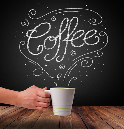 Steaming cup of coffee with white doodle line art and coffee inscriptionの写真素材