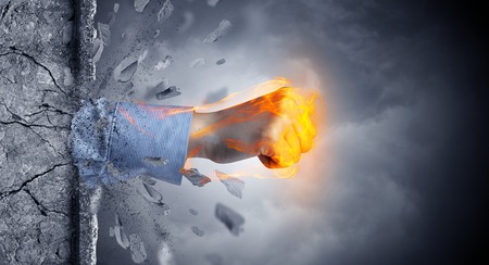 Big hand hits intense and breaks a crass stonewallの写真素材