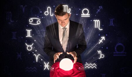 Young handsome astronaut looking for inspiration in his crystal magic ballの写真素材