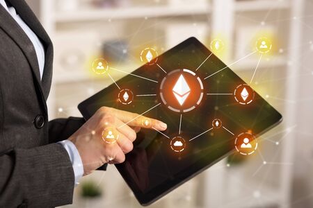 Business woman using tablet with cryptocurrency bitcoin link network and online conceptの写真素材
