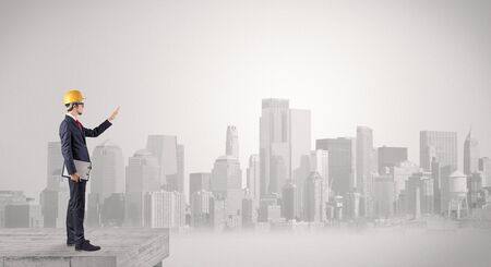 Architect standing on maze and looking at a future planの写真素材