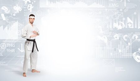 Young karate trainer doing karate tricks on the top of a metropolitan cityの写真素材