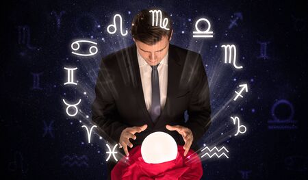 Young handsome astronaut looking for inspiration in his crystal magic ballの写真素材