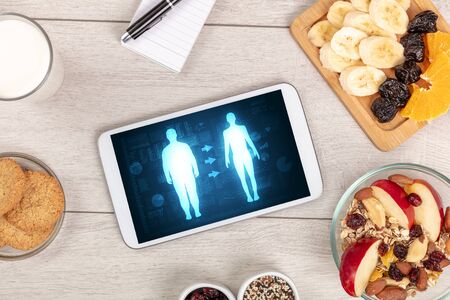 Arrangement of healthy Ingredients with a tablet. Dieting conceptの写真素材